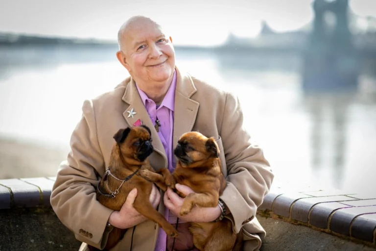 elderly people and their companion animals - image of elderly man holding his 2 dogs